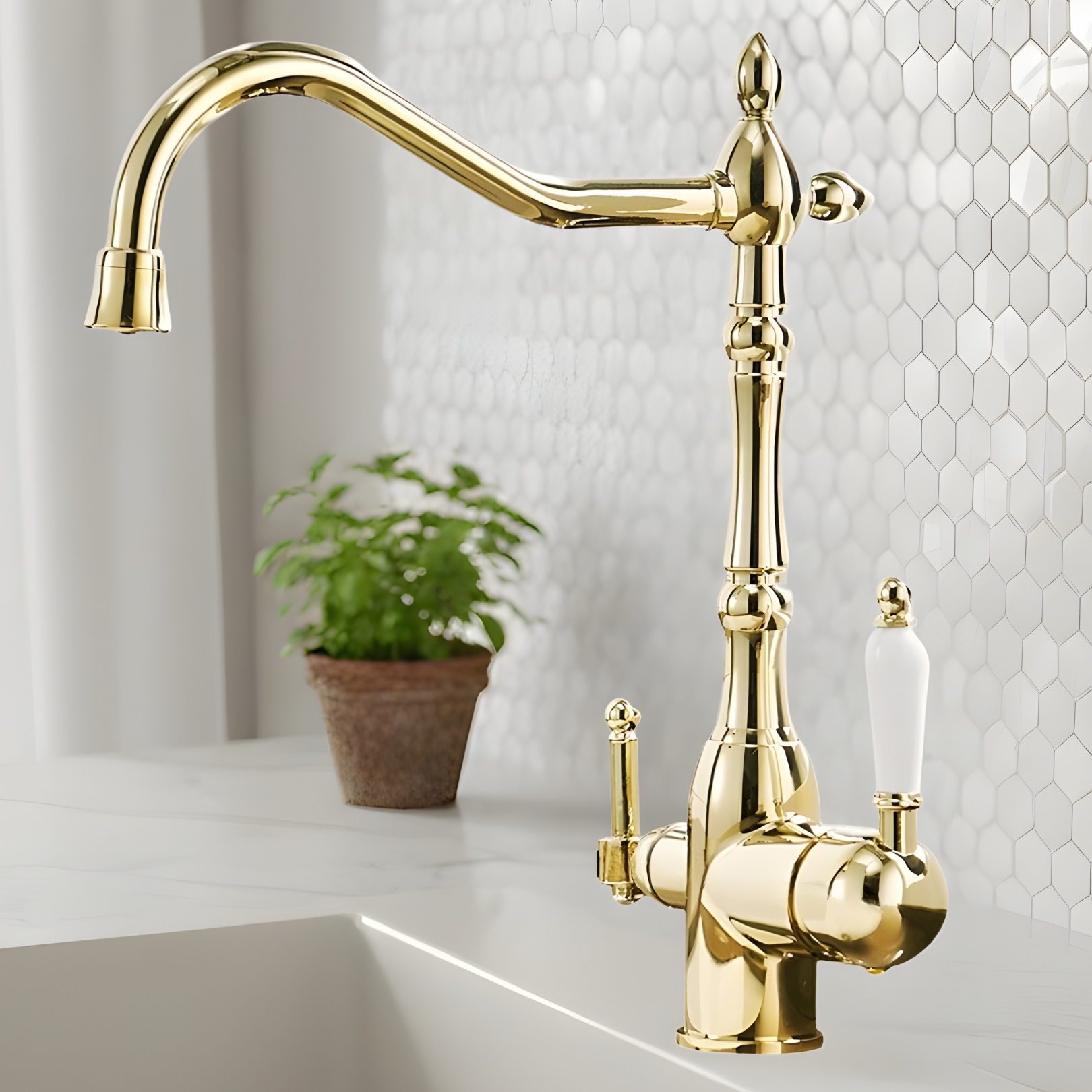 Gold kitchen faucet with a white sink and hexagonal tile backsplash