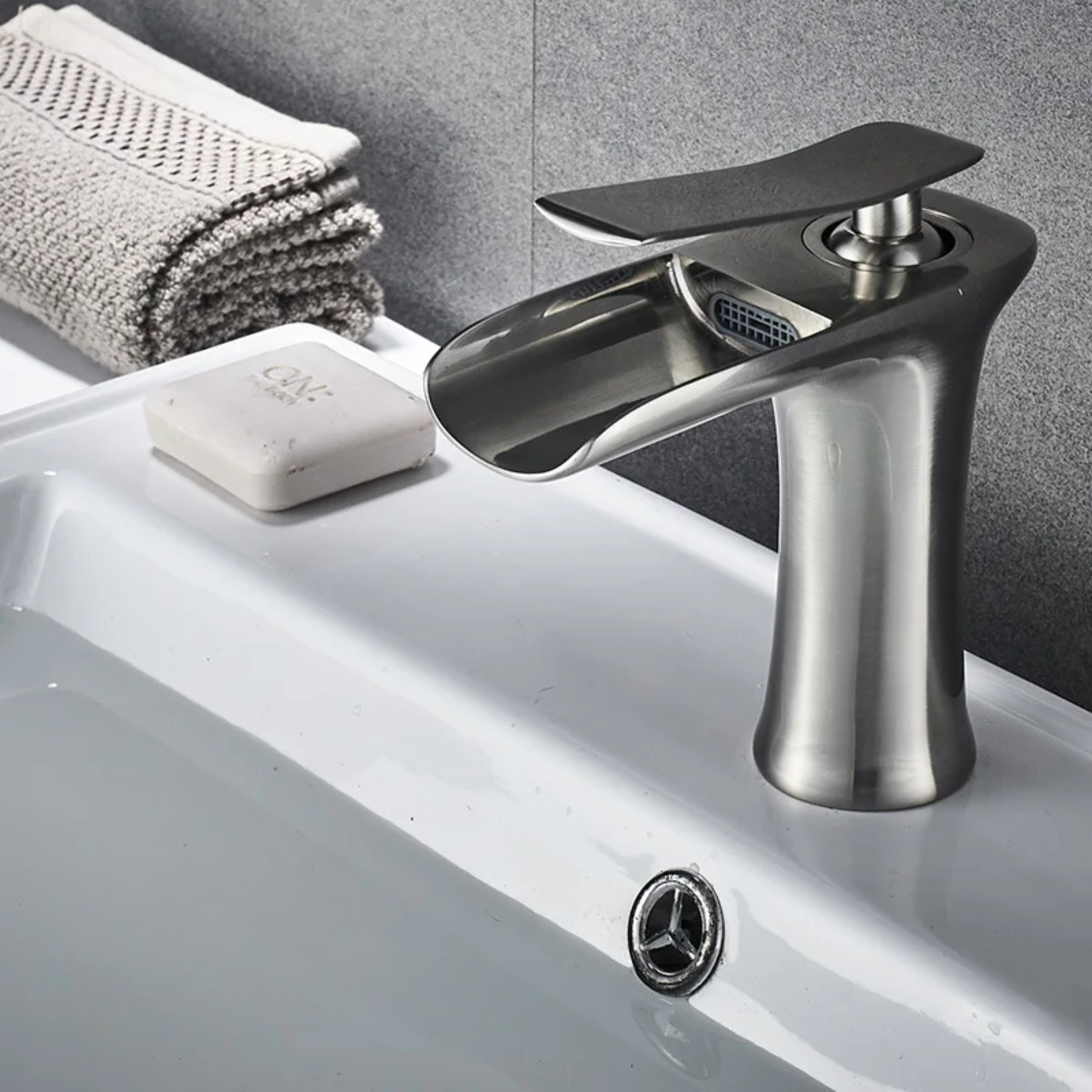 Brushed Nickel kitchen faucet attached to a sink, featuring a smooth, shiny finish for a modern and elegant look.