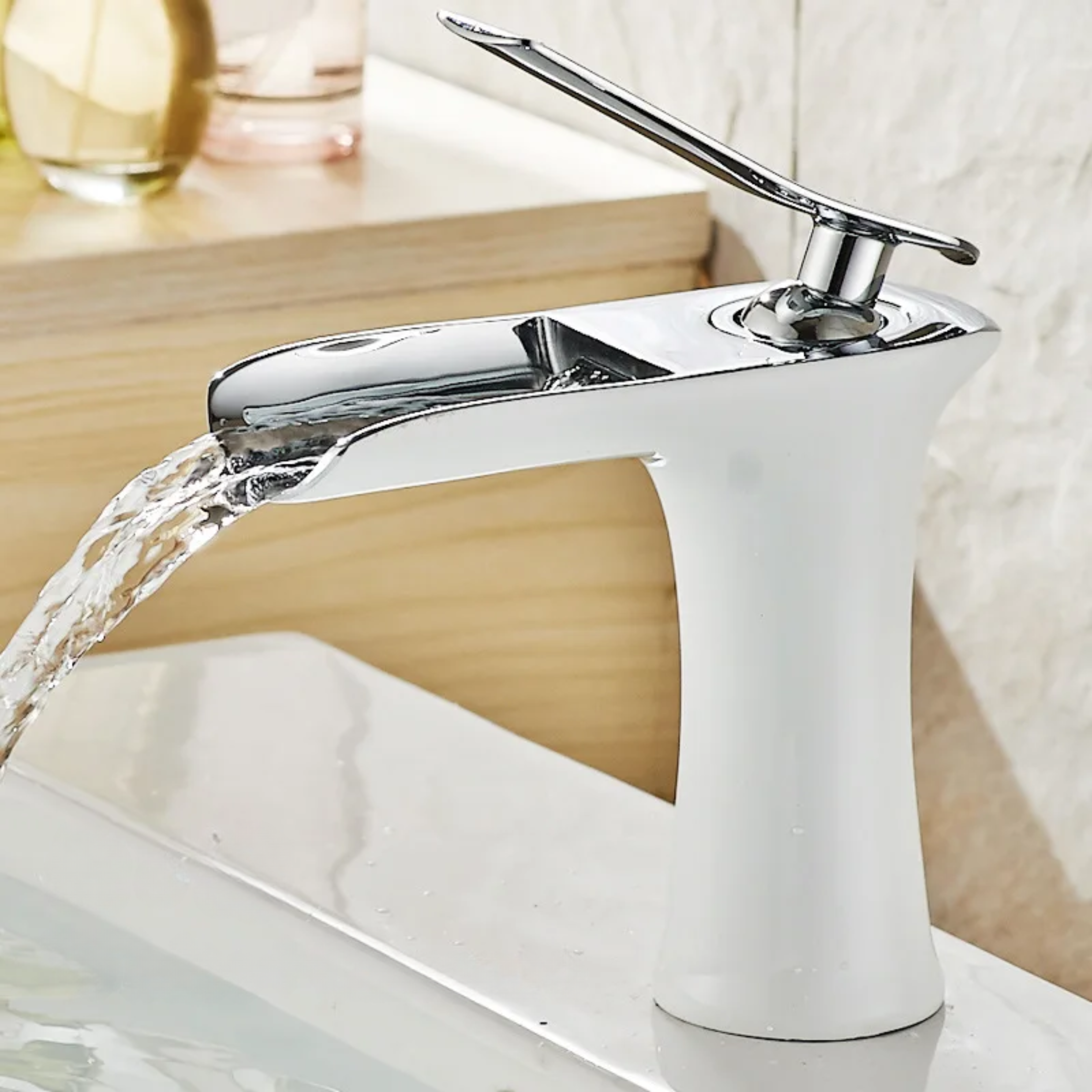 White and Chrome kitchen faucet attached to a sink, featuring a smooth, shiny finish for a modern and elegant look.