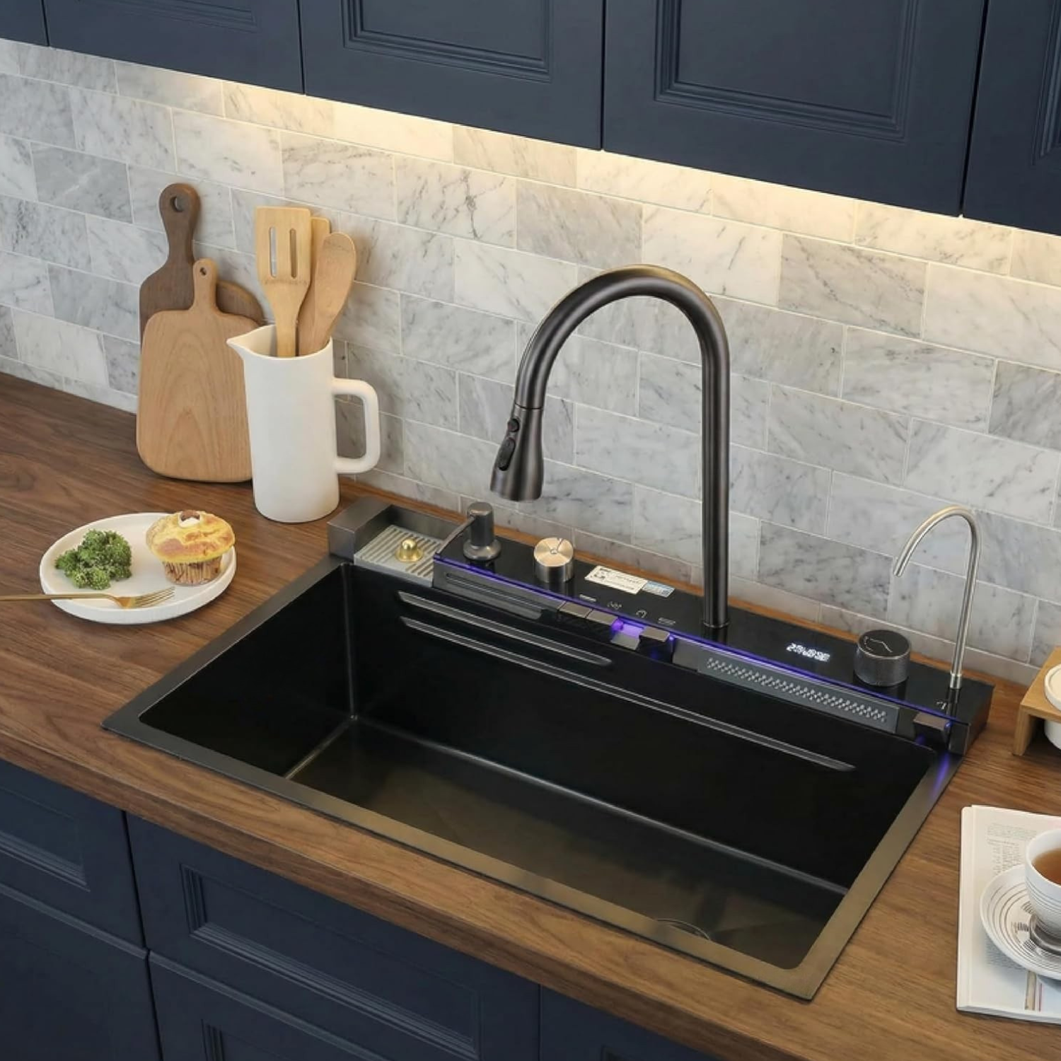 Modern kitchen sink with black faucet and wooden utensils on a countertop.