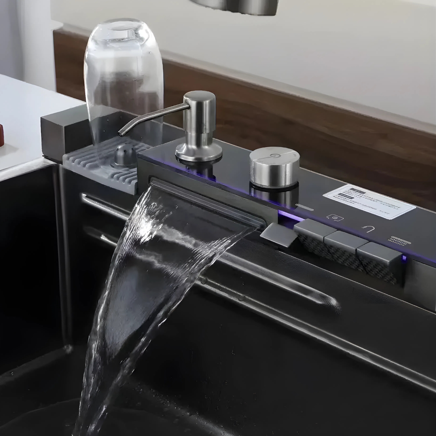 Modern kitchen sink with water flowing, featuring a sleek faucet and control panel.