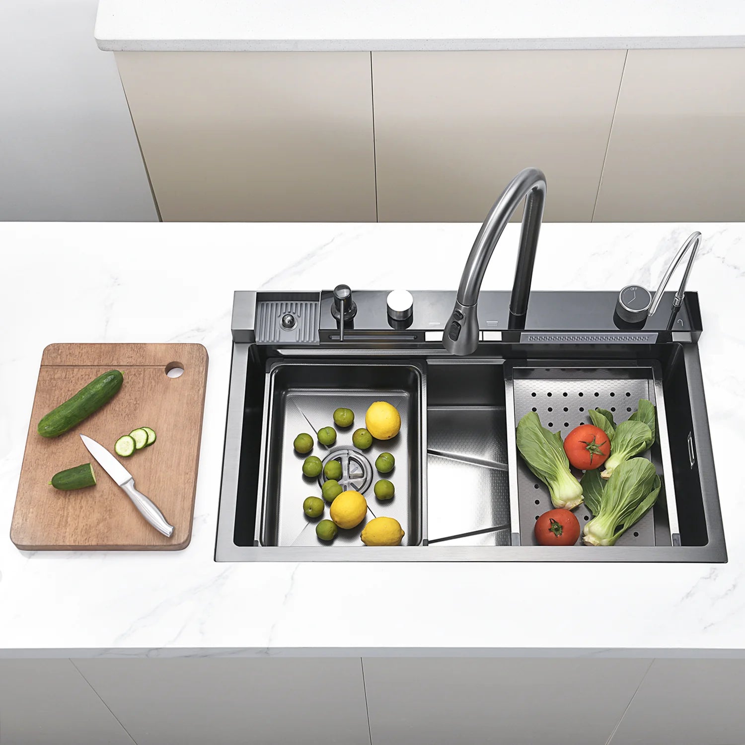 Stainless steel kitchen sink with vegetables and a cutting board on a white countertop.